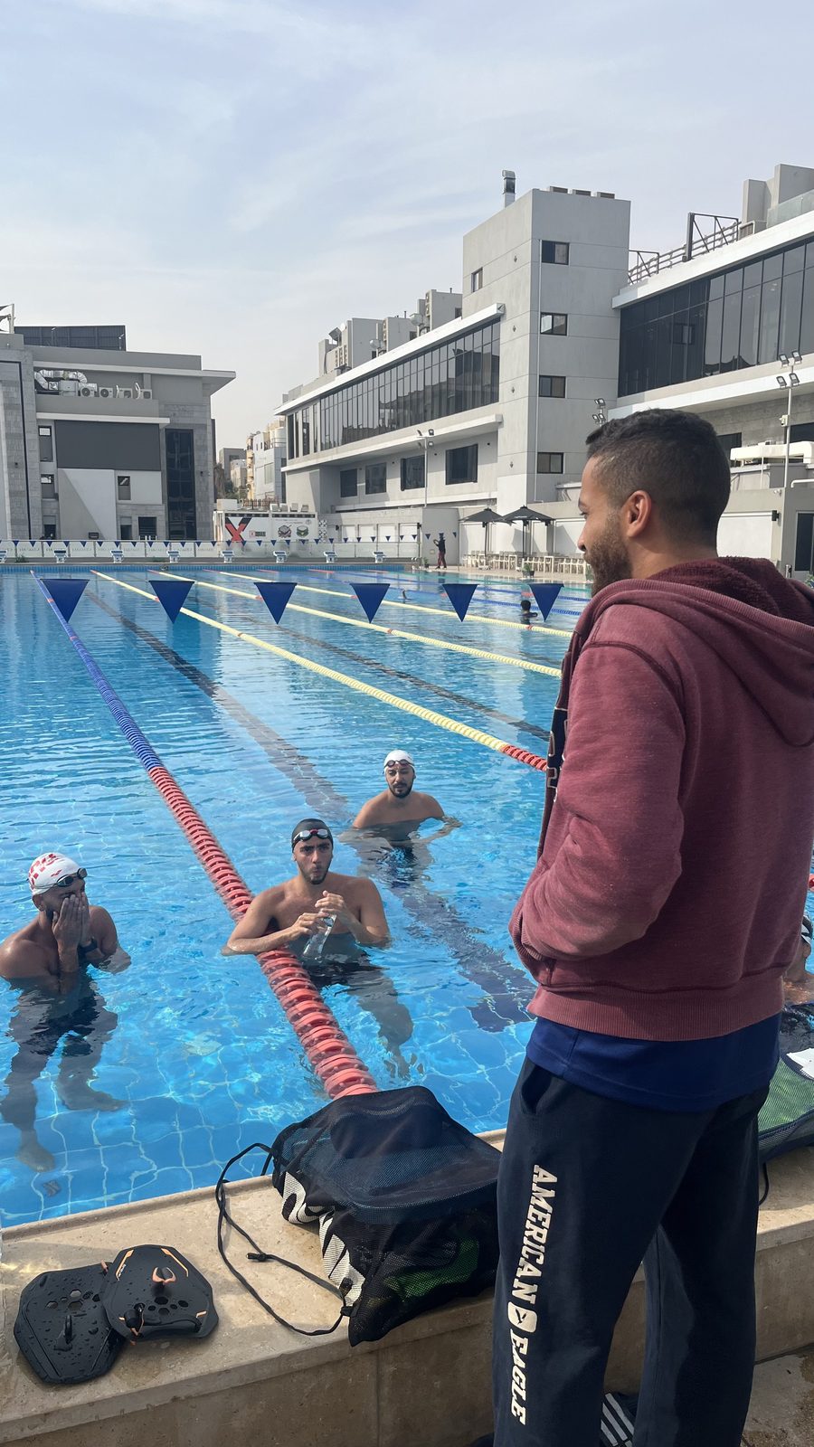Anas Nezar coaching swimmers at the pool
